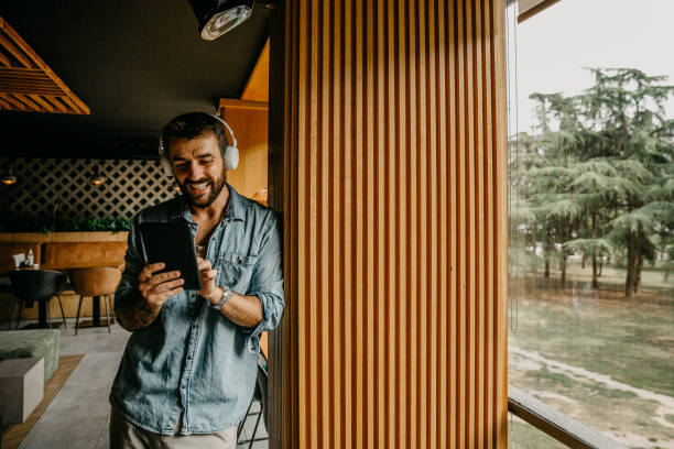 A man enjoying an app installed in his phone.