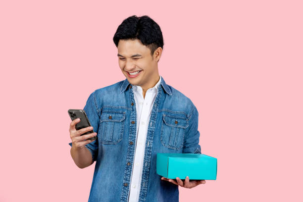 A man smiling looking at his phone